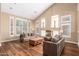 Bright living room with vaulted ceiling, wood floors, fireplace, and modern decor at 24916 N 80Th Ln, Peoria, AZ 85383