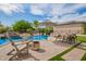 Inviting pool area with patio furniture, waterfall feature, and lush landscaping at 24916 N 80Th Ln, Peoria, AZ 85383
