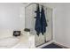 A modern shower with glass enclosure and decorative towels adds elegance to the bathroom space at 24916 N 80Th Ln, Peoria, AZ 85383