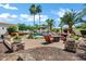 Expansive backyard features a pool, outdoor seating, fire pit, and beautifully manicured landscaping at 2527 E Beechnut Ct, Chandler, AZ 85249