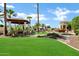 Landscaped backyard featuring a gazebo, lounge area, mature trees, and gravel detail at 2527 E Beechnut Ct, Chandler, AZ 85249