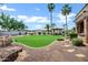 Expansive backyard with manicured lawn, palm trees, and a charming gazebo at 2527 E Beechnut Ct, Chandler, AZ 85249