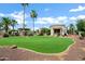 Lush backyard featuring mature trees, a large lawn, and beautiful desert landscaping at 2527 E Beechnut Ct, Chandler, AZ 85249