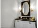 The bathroom has a unique design with decorative mirror, sconces and custom vanity at 2527 E Beechnut Ct, Chandler, AZ 85249