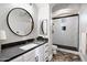 Bathroom with a modern sink, a large round mirror, and a shower with black trim at 2527 E Beechnut Ct, Chandler, AZ 85249