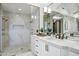 Spa-like bathroom with marble countertops, brass fixtures, and a glass-enclosed shower at 2527 E Beechnut Ct, Chandler, AZ 85249