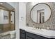 Bathroom features a round mirror, modern vanity, elegant tiles, and a glass-enclosed shower at 2527 E Beechnut Ct, Chandler, AZ 85249