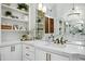Bathroom vanity showcasing marble counters, bronze fixtures, and custom built-in shelving at 2527 E Beechnut Ct, Chandler, AZ 85249