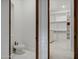 Bright white bath with bidet, walk-in closet with shelves and drawers at 2527 E Beechnut Ct, Chandler, AZ 85249