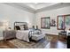 Bedroom featuring a black metal bed frame, hardwood floors, and window shutters for natural light at 2527 E Beechnut Ct, Chandler, AZ 85249