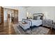 Comfortable bedroom with a black metal bed frame, stylish rug, and wood floors at 2527 E Beechnut Ct, Chandler, AZ 85249