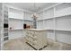 Spacious walk-in closet with custom shelving, drawers, and a chandelier at 2527 E Beechnut Ct, Chandler, AZ 85249