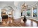 Spacious dining room with hardwood floors, chandelier, and windows providing natural light with kitchen view at 2527 E Beechnut Ct, Chandler, AZ 85249
