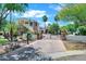 Stunning two-story home featuring stone accents, a tile roof, and a gated driveway entrance at 2527 E Beechnut Ct, Chandler, AZ 85249