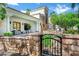 Stunning home exterior with stone accents, manicured landscaping, and gated entry at 2527 E Beechnut Ct, Chandler, AZ 85249