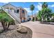 Impressive house featuring a circular driveway, landscaped grounds, and an attached three-car garage at 2527 E Beechnut Ct, Chandler, AZ 85249