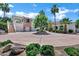 Attractive home showcasing a circular driveway, three-car garage, and meticulous landscaping at 2527 E Beechnut Ct, Chandler, AZ 85249