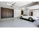 Clean and organized garage with epoxy flooring, storage cabinets, and a classic white sports car at 2527 E Beechnut Ct, Chandler, AZ 85249