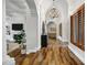 Grand hallway with stone accents, hardwood floors, and arched doorways leading to other rooms at 2527 E Beechnut Ct, Chandler, AZ 85249