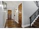 Elegant hallway with hardwood floors, stylish light fixtures, and wood doors leads to the stairway at 2527 E Beechnut Ct, Chandler, AZ 85249