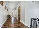 Hallway with hardwood floors, wood doors, and an alcove with a table and chairs at 2527 E Beechnut Ct, Chandler, AZ 85249