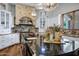 This kitchen features white cabinets, stone accents and granite counters illuminated by modern pendant lighting at 2527 E Beechnut Ct, Chandler, AZ 85249
