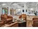 Stunning living room with vaulted ceilings, stone accents, and comfortable leather chairs creating a luxurious and inviting space at 2527 E Beechnut Ct, Chandler, AZ 85249