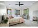 Large main bedroom with a ceiling fan, carpet, and wood shuttered windows at 2527 E Beechnut Ct, Chandler, AZ 85249