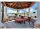 Covered outdoor kitchen with stone counters, stainless steel grill, and comfortable seating area at 2527 E Beechnut Ct, Chandler, AZ 85249