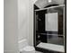 Black tile shower featuring glass doors, with sleek fixtures at 2527 E Beechnut Ct, Chandler, AZ 85249