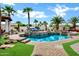 Stunning swimming pool surrounded by lush landscaping and palm trees, creating a tropical oasis at 2527 E Beechnut Ct, Chandler, AZ 85249