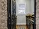 View into a wine cellar with custom iron door, black cabinets and granite countertop at 2527 E Beechnut Ct, Chandler, AZ 85249