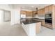 Stylish kitchen with a central island, stainless appliances, and ample cabinet space at 26139 S 225Th Way, Queen Creek, AZ 85142