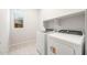 New laundry room with washer, dryer and built in shelving at 26139 S 225Th Way, Queen Creek, AZ 85142
