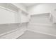 Walk-in closet with all-white shelving and carpeting at 26139 S 225Th Way, Queen Creek, AZ 85142