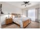 Cozy bedroom featuring a comfortable bed, neutral decor, and a ceiling fan at 2685 N 132Nd Dr, Goodyear, AZ 85395
