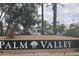 Palm Valley community sign surrounded by palm trees and parked cars at 2685 N 132Nd Dr, Goodyear, AZ 85395