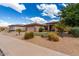 Well-manicured front lawn with desert landscaping complements this home’s exterior and two car garage at 2685 N 132Nd Dr, Goodyear, AZ 85395