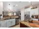 Updated kitchen with granite countertops, stainless steel appliances, and seamless transition to living area at 2685 N 132Nd Dr, Goodyear, AZ 85395