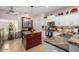 Features a kitchen island, modern appliances, granite countertops, and tiled backsplash at 2685 N 132Nd Dr, Goodyear, AZ 85395