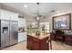 Open kitchen showcases an island with granite countertops, stainless steel appliances, and an open layout at 2685 N 132Nd Dr, Goodyear, AZ 85395