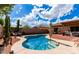 Serene pool area featuring comfortable seating, lush greenery, and a tranquil atmosphere at 2685 N 132Nd Dr, Goodyear, AZ 85395