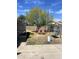 Backyard featuring a tree and swing set, offering a serene outdoor space at 2802 W Lawrence Rd, Phoenix, AZ 85017