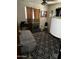 Simple bedroom with gray carpet and a window that allows natural light at 2802 W Lawrence Rd, Phoenix, AZ 85017