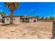 Large open backyard ready for landscaping, showcasing the property's exterior with desert foliage at 3013 W Port Au Prince Ln, Phoenix, AZ 85053