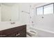 This bathroom features a tiled shower-tub combination and a dark-wood vanity at 3013 W Port Au Prince Ln, Phoenix, AZ 85053