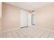 This bedroom features tile flooring, and a white double closet door at 3013 W Port Au Prince Ln, Phoenix, AZ 85053