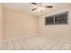 Bedroom featuring tile flooring, neutral paint, and a ceiling fan at 3013 W Port Au Prince Ln, Phoenix, AZ 85053