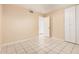 This bedroom features tiled floors, an open closet door, and a closet with sliding doors at 3013 W Port Au Prince Ln, Phoenix, AZ 85053