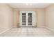Cozy dining area featuring tile floors and access to backyard through french doors at 3013 W Port Au Prince Ln, Phoenix, AZ 85053